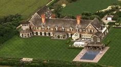 an aerial view of a large house with a pool