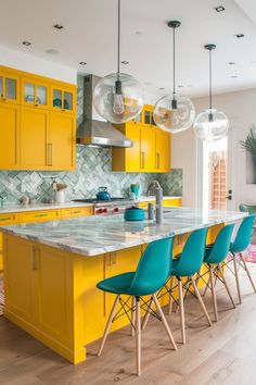 a kitchen with yellow cabinets and blue chairs in the center island, surrounded by hanging glass globes