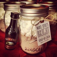 three mason jars filled with white cotton balls and labeled make spirits bright