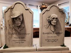 two tombstones decorated with heads and bones