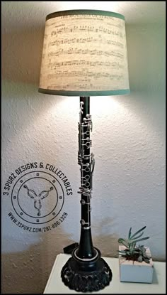 a lamp that is sitting on top of a table next to a box with music notes