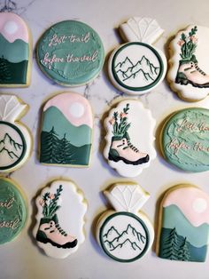 decorated cookies with frosting and designs on top of a marble countertop in the shape of mountains