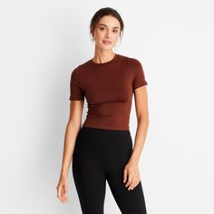 This Seamless Jersey Crop Top from A New Day™ in a solid colors offers easy pairing with a range of looks. Fashioned in a cropped length, it features a classic crewneck and a slim silhouette to give you a fitted look. The lightweight fabric with added stretch and a seamless design offers a more comfortable fit, and you can wear it with your choice of bottoms to create a range of versatile styles. . A New Day™: Style that goes wherever you do. Basic Solid Cropped T-shirt With Ribbed Detail, Versatile Short Sleeve Crop Top, Fitted Brown Short Sleeve Crop Top, Brown Fitted Short Sleeve Crop Top, Solid Color Ribbed Short Sleeve Stretch Top, Fitted Brown Crop Top With Short Sleeves, Solid Color Fitted Top For Loungewear, Versatile Fitted Crop Top With Short Sleeves, Solid Ribbed Stretch Short Sleeve Top