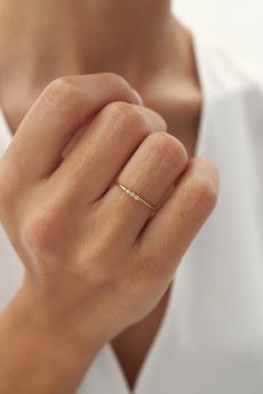 a woman wearing a diamond ring on her finger