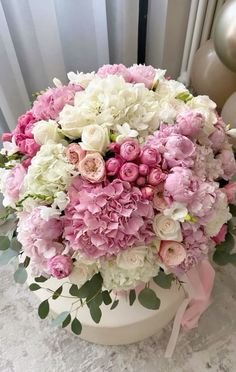 a bouquet of pink and white flowers in a vase