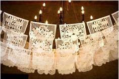 a chandelier made out of lace and candles