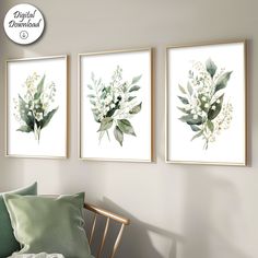 three framed floral prints on the wall above a green chair with pillows and throw pillow