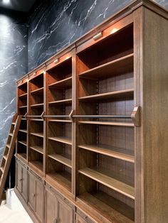 an empty bookcase with stairs leading up to it