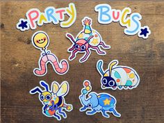 party bugs stickers sitting on top of a wooden table