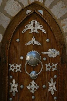 a wooden door with metal decorations on it