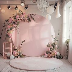 a pink backdrop with flowers on the floor