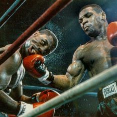 two men in the ring with boxing gloves on, one is punching the other's head