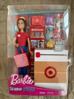 the barbie doll is holding a shopping bag and some other items in her handbag