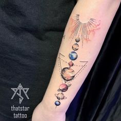 a woman with a tattoo on her arm that has planets and stars all over it