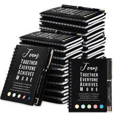 a stack of black notebooks with white writing on the front and back covers that read team together everyone achieve more