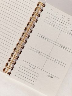 an open spiral notebook sitting on top of a table