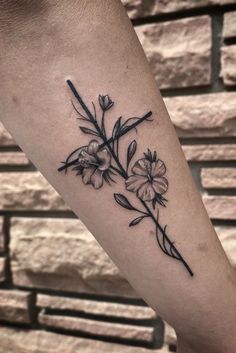 a black and white flower tattoo on the arm