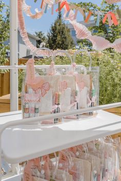 some pink and white items on a table with bunting streamers in the background