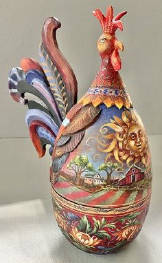 a colorful rooster shaped vase sitting on top of a table