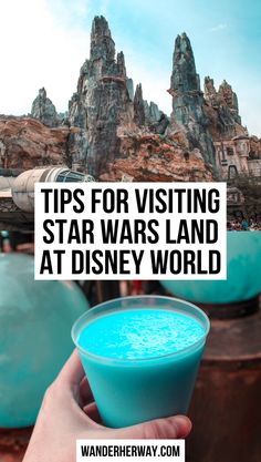 a hand holding a blue drink with the words tips for visiting star wars land at disney world