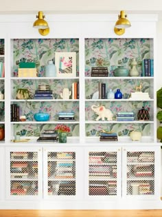 a white bookcase filled with lots of books