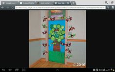 a screen shot of a door decorated with flowers and bees on the front, and an image of a tree in the back