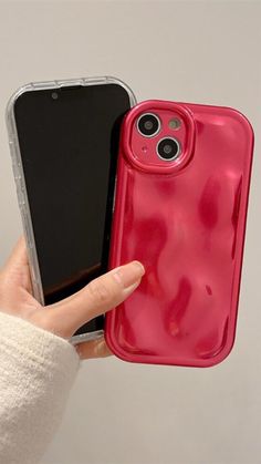 a person holding an iphone case in their left hand and another cell phone on the other