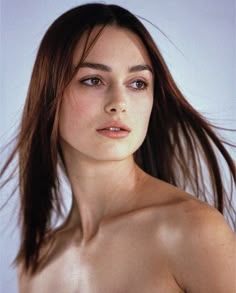 a woman with very long hair posing for the camera