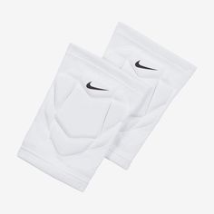 two white knee pads with black nike logo