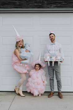 a man and woman dressed up as unicorns pose for a photo with their daughter