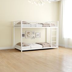 a white bunk bed sitting on top of a hard wood floor