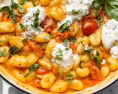 a pot filled with pasta and cheese on top of a table