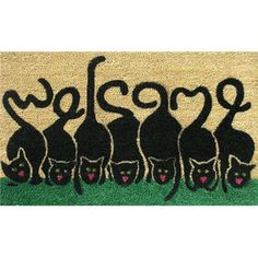 a welcome door mat with black cats on it and the word welcome written in pink