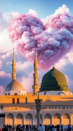 the clouds are blowing in the shape of a heart over an ornate building with dome tops