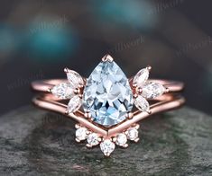 an engagement ring with a pear shaped diamond