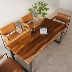 a wooden table with chairs around it and a book on the table next to it