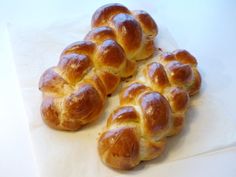 several pieces of bread sitting on top of a piece of parchment paper next to each other