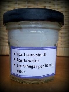 a jar of water sitting on top of a wooden table