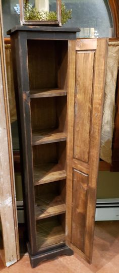 an old wooden cabinet with glass doors on the front and bottom shelves is shown in this photo