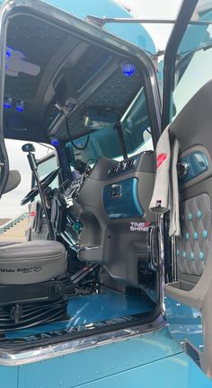 the interior of a blue truck with its doors open