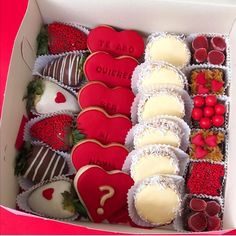 a box filled with lots of different types of heart shaped cookies on top of each other