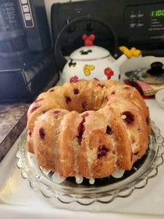 a bundt cake sitting on top of a glass plate next to a microwave oven