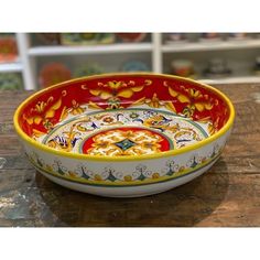 a colorful bowl sitting on top of a wooden table