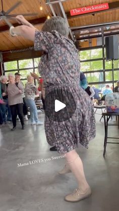 a woman in a dress is dancing on the dance floor