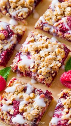 raspberry crumble bars with white icing and fresh raspberries on top