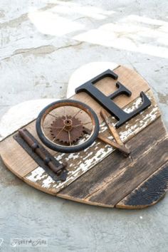 a wooden sign that says love with a compass on it