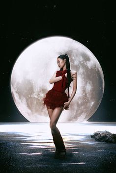 a woman in a short red dress standing on the beach