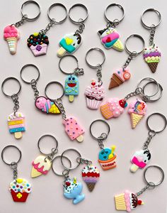 a bunch of key chains that have different types of items on them, all in different colors