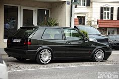 a black car parked in front of a building