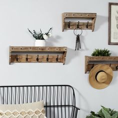 three wooden shelves are mounted on the wall above a bed with pillows and throw pillows